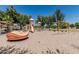 A playground with a variety of slides, swings, and climbing structures, set in a sandy play area at 30 W Sheffield Ave, Gilbert, AZ 85233