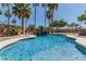 Beautiful pool area with a rock waterfall feature, lush landscaping, and inviting blue water at 30 W Sheffield Ave, Gilbert, AZ 85233