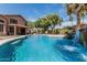 Backyard pool with rock waterfall feature and lush landscaping at 30 W Sheffield Ave, Gilbert, AZ 85233