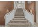 Carpeted staircase with wooden handrails and neutral wall decor, leading to the upper level at 30 W Sheffield Ave, Gilbert, AZ 85233
