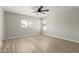 Neutral bedroom with wood floors, multiple windows, and a modern ceiling fan at 3035 W Roberta Dr, Phoenix, AZ 85083