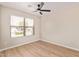 Bright bedroom featuring a ceiling fan, window, and neutral-colored walls at 3035 W Roberta Dr, Phoenix, AZ 85083