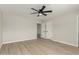 Neutral bedroom with light wood floors, a modern ceiling fan, and open doorway at 3035 W Roberta Dr, Phoenix, AZ 85083