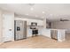 Bright kitchen featuring stainless steel appliances, white cabinets, and wood-look flooring at 3035 W Roberta Dr, Phoenix, AZ 85083