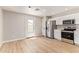 Bright kitchen showcasing stainless steel appliances, white cabinets, and stylish backsplash at 3035 W Roberta Dr, Phoenix, AZ 85083