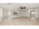 Open-concept living room with light wood flooring, neutral paint, and modern ceiling fan at 3035 W Roberta Dr, Phoenix, AZ 85083