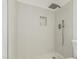 Modern tiled shower featuring a rain shower head, niche, and contemporary fixtures at 3035 W Roberta Dr, Phoenix, AZ 85083