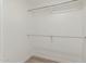 An empty walk-in closet with clothing rods and neutral paint at 3035 W Roberta Dr, Phoenix, AZ 85083