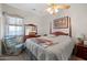 Cozy bedroom with a four-poster bed, ceiling fan and a matching wood dresser at 3085 E Parkview Dr, Gilbert, AZ 85295