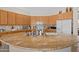 Bright kitchen with oak cabinets, granite countertops, a center island, and stainless steel appliances at 3085 E Parkview Dr, Gilbert, AZ 85295
