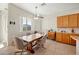 Bright kitchen nook with natural lighting, a ceiling fan and a tile table with four chairs at 3085 E Parkview Dr, Gilbert, AZ 85295