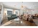 Bright living room with wood floors, large windows, two sofas and a glass top coffee table at 3085 E Parkview Dr, Gilbert, AZ 85295