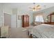 Elegant bedroom with warm lighting, a comfortable seating area, and large armoire at 3085 E Parkview Dr, Gilbert, AZ 85295