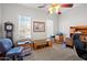 Bright office space featuring a ceiling fan, two large windows and neutral carpet flooring at 3085 E Parkview Dr, Gilbert, AZ 85295