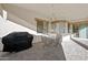 Covered patio features a ceiling fan, stylish pavers, and space for outdoor dining or entertaining at 3085 E Parkview Dr, Gilbert, AZ 85295