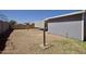 View of the large backyard with a dirt surface and cinder block wall at 319 S 90 Pl, Mesa, AZ 85208