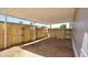 View of the large backyard with a covered patio and a wooden fence at 319 S 90 Pl, Mesa, AZ 85208