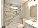 Updated bathroom featuring a step-in shower with luxurious marble-patterned tiling at 319 S 90 Pl, Mesa, AZ 85208