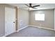 Spacious bedroom with neutral carpeting, ceiling fan, and a bright window at 319 S 90 Pl, Mesa, AZ 85208