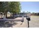 Charming single-story home features a covered parking, lush trees, and gravel landscaping at 319 S 90 Pl, Mesa, AZ 85208