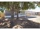 Charming single-story home with a covered parking area and mature trees at 319 S 90 Pl, Mesa, AZ 85208