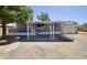 Single-story home with a covered parking area and a well-maintained exterior at 319 S 90 Pl, Mesa, AZ 85208