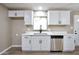 Modern kitchen featuring stainless steel appliances and stylish white cabinetry at 319 S 90 Pl, Mesa, AZ 85208