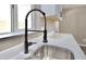 Close-up of a modern kitchen sink with a sleek faucet and a bright window view at 319 S 90 Pl, Mesa, AZ 85208