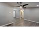 Open-concept living room featuring modern flooring, a ceiling fan, and neutral color palette at 319 S 90 Pl, Mesa, AZ 85208