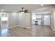 Spacious open-concept featuring sleek floors, modern lighting, and flows into the kitchen at 319 S 90 Pl, Mesa, AZ 85208