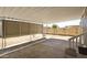 A covered patio with a concrete floor overlooks the partially fenced backyard at 319 S 90 Pl, Mesa, AZ 85208