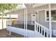 Welcoming covered front porch with decorative railing and white trim accents at 319 S 90 Pl, Mesa, AZ 85208