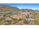 Desert home with a pool, surrounded by lush landscaping and mountain views at 3553 N Crystal Peak Cir, Mesa, AZ 85207