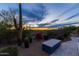 Beautifully landscaped backyard with a custom-built outdoor seating area, and sunset views at 3553 N Crystal Peak Cir, Mesa, AZ 85207