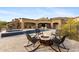 Luxury home backyard with a pool, spa, fire pit, and desert views at 3553 N Crystal Peak Cir, Mesa, AZ 85207