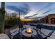 Beautiful backyard with a pool, hot tub, fire pit and desert landscaping at sunset at 3553 N Crystal Peak Cir, Mesa, AZ 85207