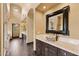 Bathroom featuring marble countertops, dark wood cabinetry, and an ornate mirror at 3553 N Crystal Peak Cir, Mesa, AZ 85207