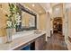 Elegant bathroom vanity with marble countertop, dark wood cabinets, and decorative mirror at 3553 N Crystal Peak Cir, Mesa, AZ 85207