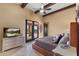 Bedroom features exposed beams, a ceiling fan, and french doors leading to the pool at 3553 N Crystal Peak Cir, Mesa, AZ 85207