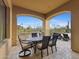 Covered patio with a dining table and chairs, perfect for outdoor meals with views of the surrounding desert landscape at 3553 N Crystal Peak Cir, Mesa, AZ 85207