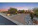 Elegant circular driveway with desert landscaping leading to a spacious three-car garage at 3553 N Crystal Peak Cir, Mesa, AZ 85207
