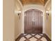 Elegant entryway features a decorative tile floor and leads to a grand, double wooden front door at 3553 N Crystal Peak Cir, Mesa, AZ 85207