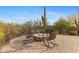 Scenic backyard featuring a stone fire pit with comfortable rocking chairs and desert landscape at 3553 N Crystal Peak Cir, Mesa, AZ 85207