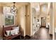 Hallway with arched ceiling, chandelier, bench and views of the ensuite bathroom and exterior at 3553 N Crystal Peak Cir, Mesa, AZ 85207