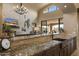 Kitchen with granite counters, stainless steel sink and view to the living room at 3553 N Crystal Peak Cir, Mesa, AZ 85207