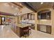 Spacious kitchen featuring large granite island, wine cooler and brickwork on ceiling at 3553 N Crystal Peak Cir, Mesa, AZ 85207