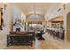 Open living room with stone fireplace, and bar area at 3553 N Crystal Peak Cir, Mesa, AZ 85207
