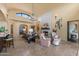 Bright living room with stone fireplace, high ceilings, open floor plan, and views of the outdoor patio at 3553 N Crystal Peak Cir, Mesa, AZ 85207
