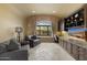 Cozy living room featuring a large window with scenic views, built-in cabinets, and comfortable seating at 3553 N Crystal Peak Cir, Mesa, AZ 85207