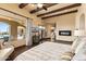 Cozy main bedroom features wood beams, a fireplace, and access to an outdoor space at 3553 N Crystal Peak Cir, Mesa, AZ 85207